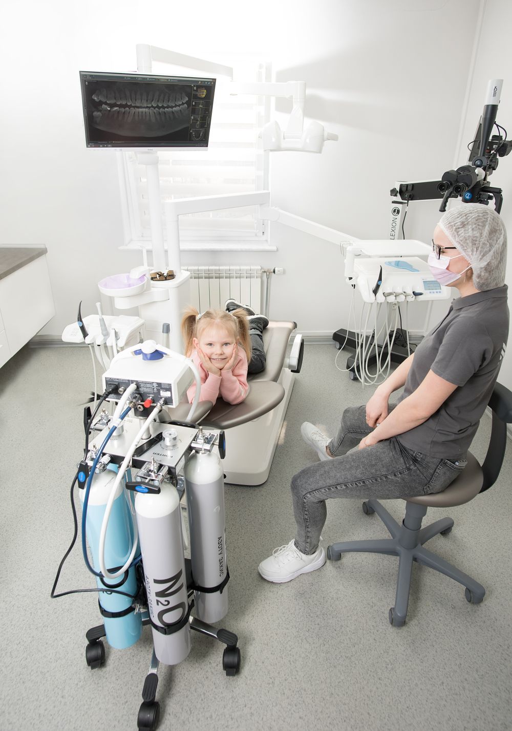 A young girl smiling during her visit to the dental clinic