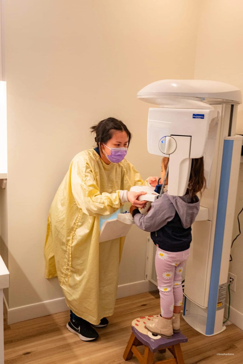 A young patient at the clinic with her parent nearby